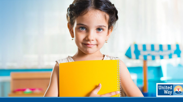 young student holding a yellow folder